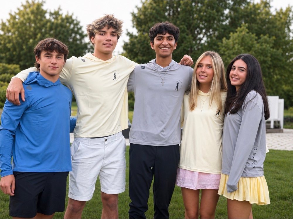 Five athletes together on the course at golden hour, wearing the DEVEN Madison Collection